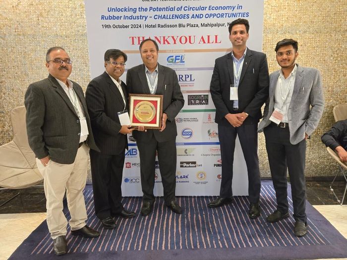 GoGreen team with the speaker plaque — GoGreen Eternal among conference sponsors